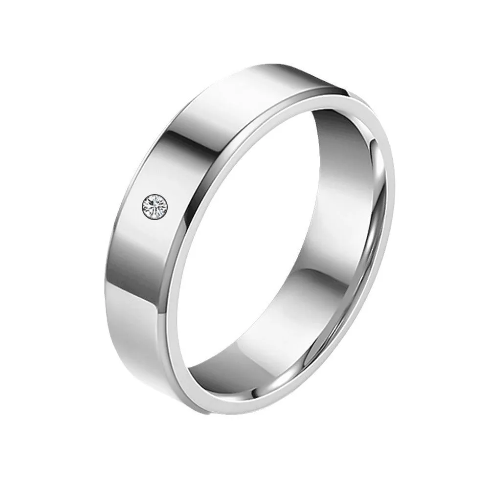 A simple, single-stone, silver-colored couple's ring
